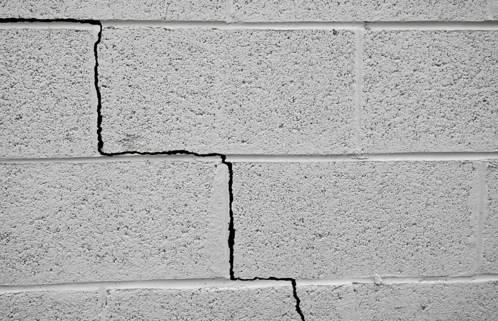 A crack following the brick pattern on a wall