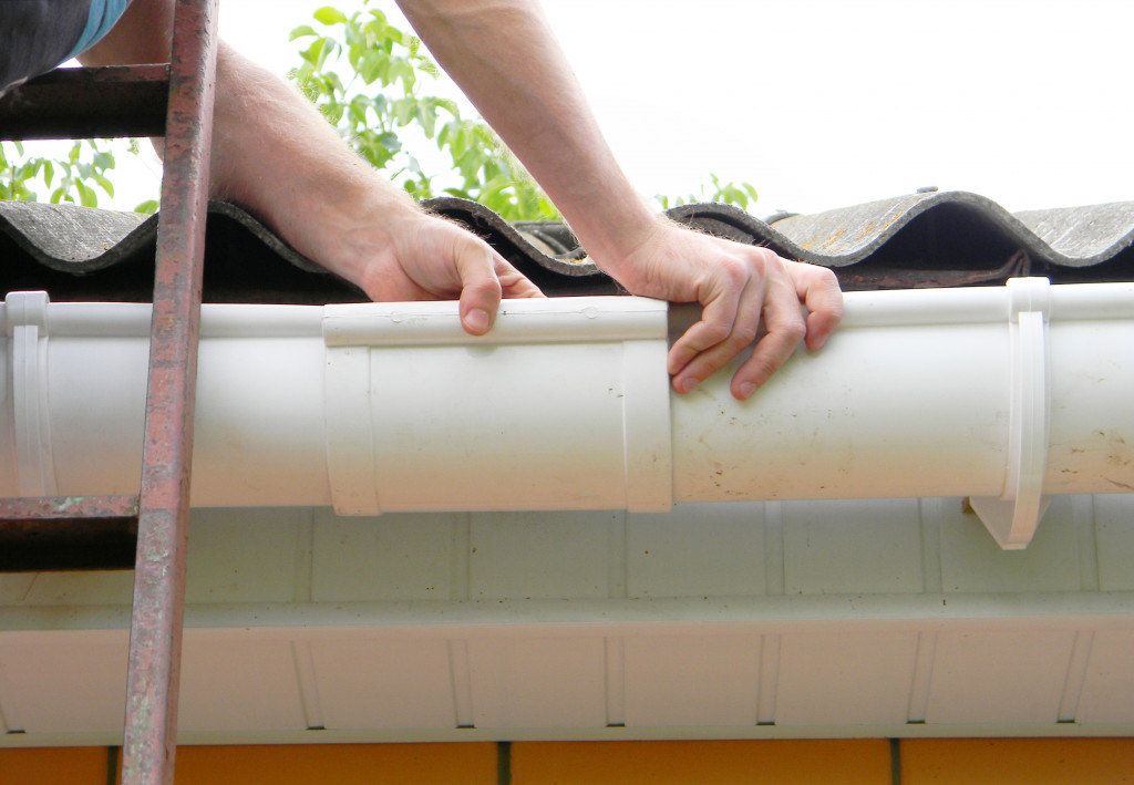 A man repairing a gutter