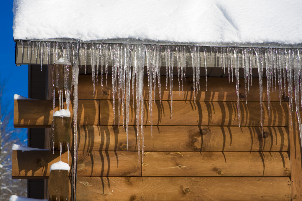 An image of ice dams forming on a log house