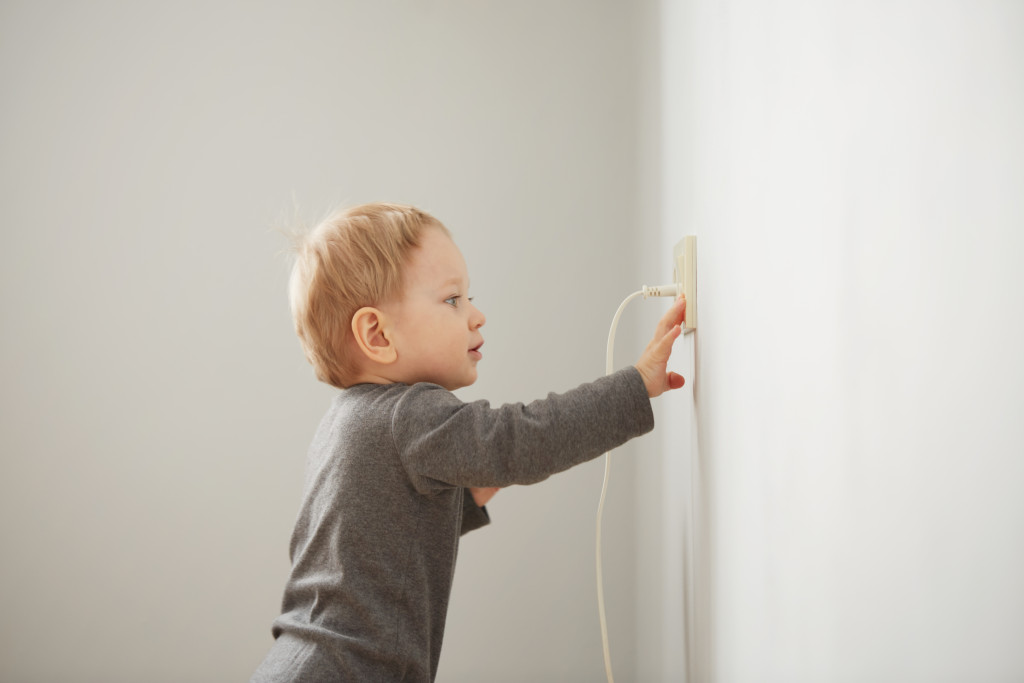 a child playing beside a socket