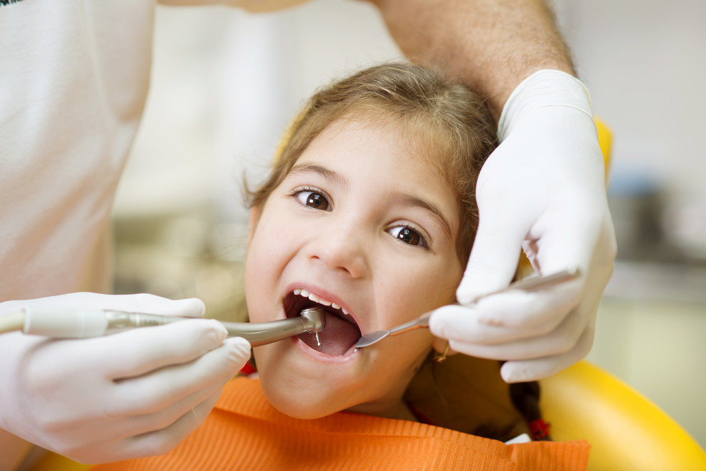 Child in dentist getting oral checkup