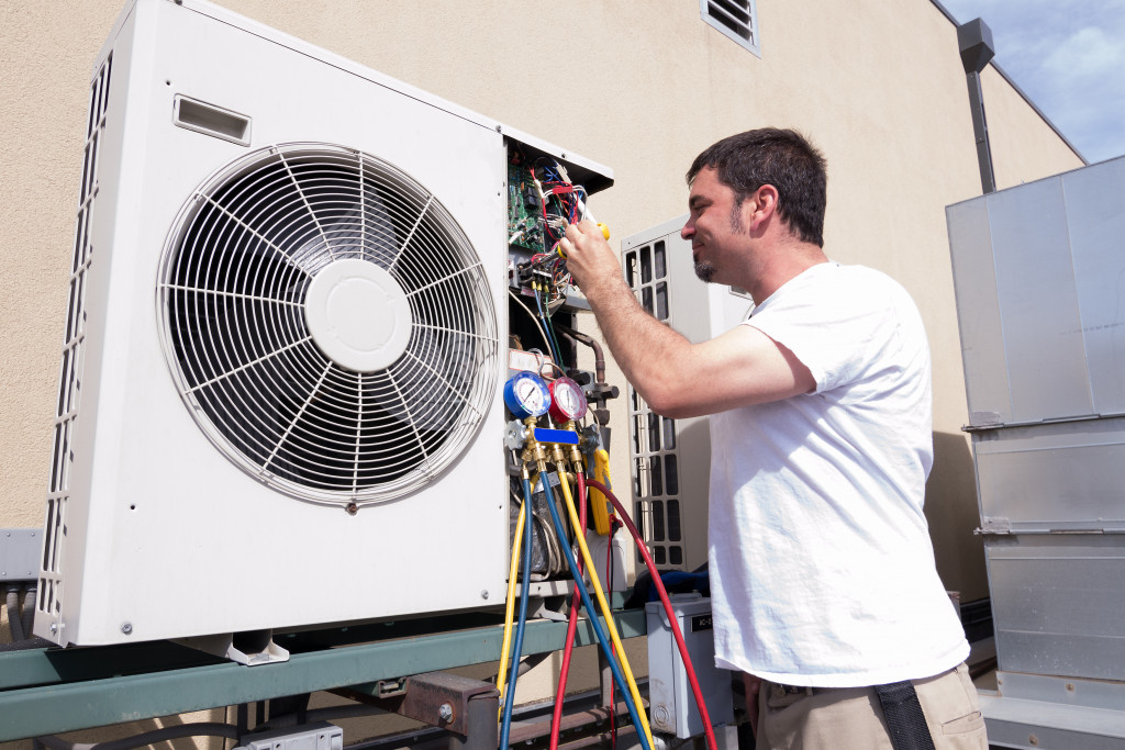 man checking and fixing the home's HVAC system