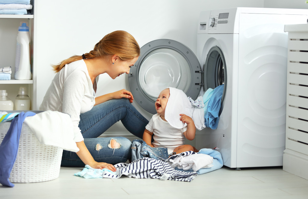 a woman smiling doing laundry