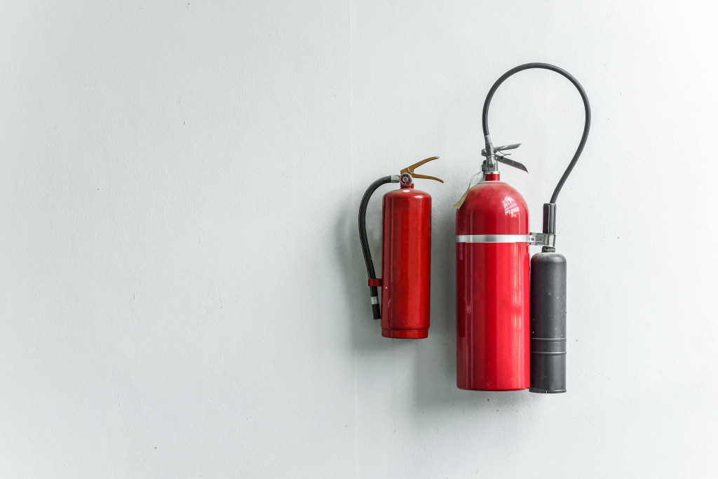 Two fire extinguishers of different sizes