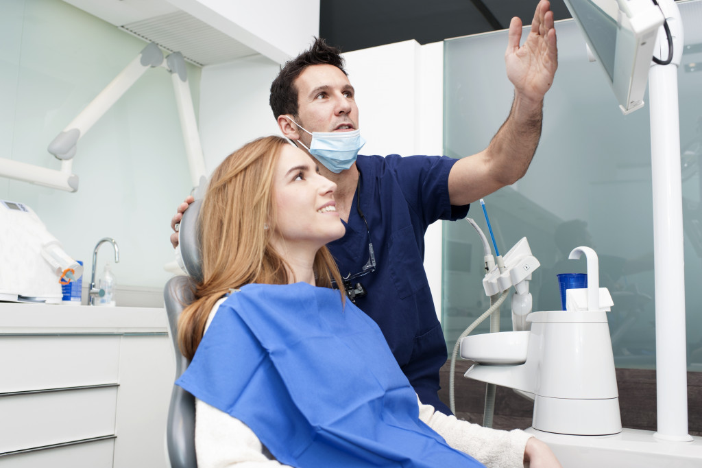 woman talking to male dentist in the clinic